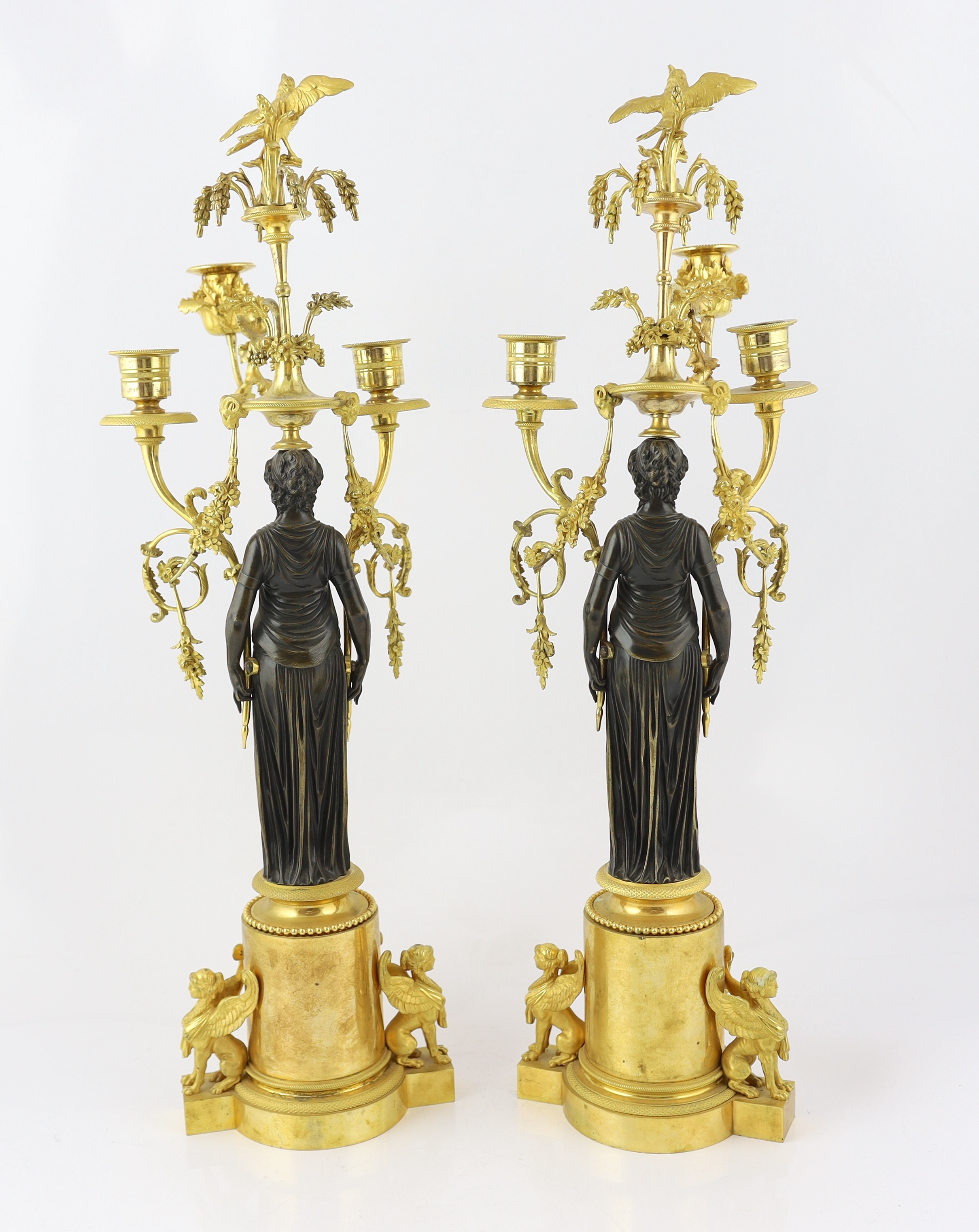 A pair of late 19th century French Empire style bronze and ormolu three light candelabra, 20cm wide, 63cm high, Please note this lot attracts an additional import tax of 5% on the hammer price